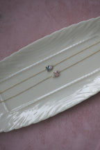Blue and pink Toi et Moi lab diamond bracelets in solid 14k gold displayed on a jewelry tray